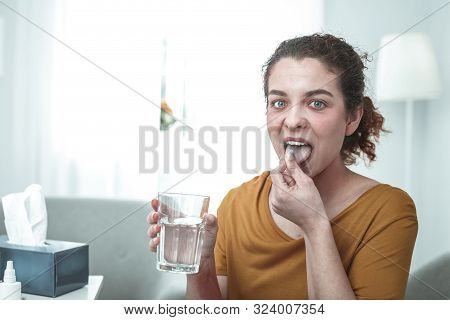 Green-eyed Woman Taking Pills While Having Strong Allergy