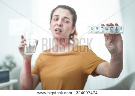 Woman Holding Glass Of Water And Pills To Treat Allergy