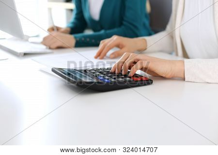 Accountant Checking Financial Statement Or Counting By Calculator Income For Tax Form, Hands Close-u
