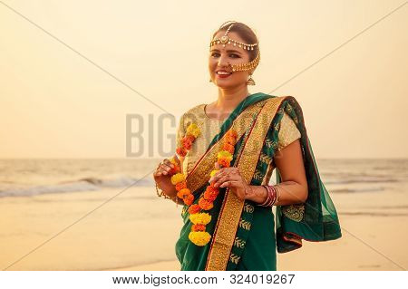Beautiful Woman Indian Wearing Green Fashion Sari, Bindis And Paint. Close Up Of Beauty Indian Woman