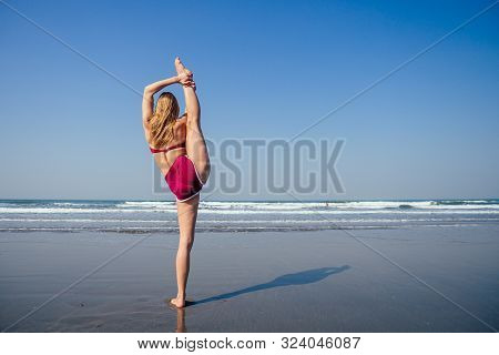 Gymnast Girl Doing Splits Grand Jete In The Air. Beautiful Young Fit Gymnast Woman Working Out, Perf