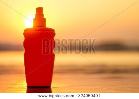 Copyspace Spf Sunscreen Sun Block Bottle On The Sand By The Sea Shore. Sunset Viagra Oil Erotic Mass