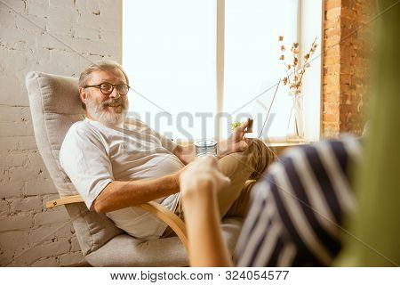 Senior Man Working With Tablet At Home - Concept Of Home Studying. Caucasian Male Model Doing His Ho