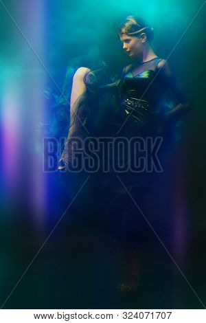Beautiful girl performs Latino dance with expression. Professional dancer in motion. Beauty, fashion.