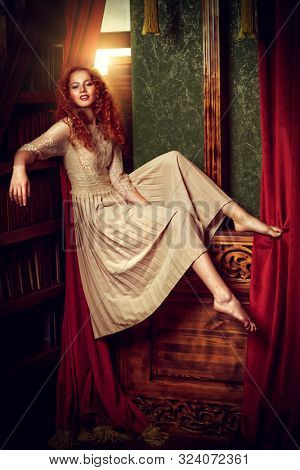 Beautiful romantic girl in a light lace dress in a vintage interior. Fairy tales. Young princess in a castle.