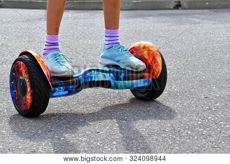 Dear Baby Present. Riding A Scooter On The Road.
