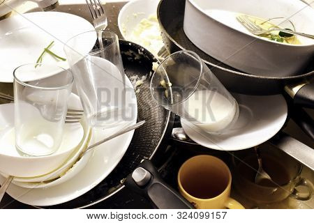 A Lot Of Dirty Dishes In The Sink After Dinner. Need For A Dishwasher And Cleaning Lady