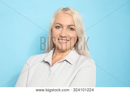 Portrait Of Mature Woman With Beautiful Face On Light Blue Background