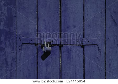 Old Blue Color Wooden Locked Door Texture Background. Door With Old Metal Lock. Close Up