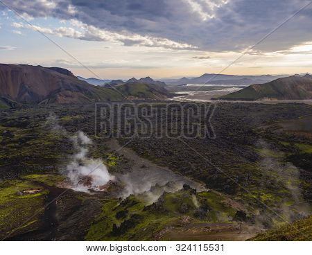 Colorful Rhyolit Mountain Panorma With Multicolored Volcanos And Geothermal Fumarole And River Delta