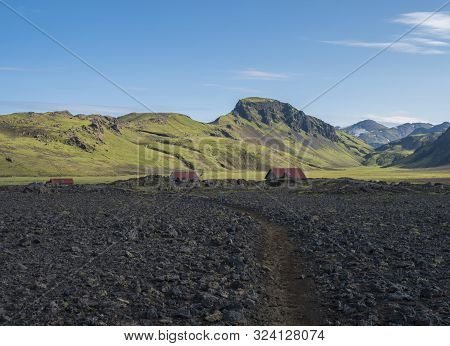 Hvanngil Campsite Path In Lava Field And Green Valley, Small Houses Of Hvanngil Hut. Volcanic Mounta