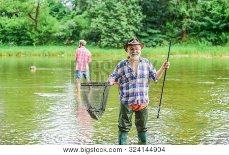 Activity And Hobby. Fishing Freshwater Lake Pond River. Bearded Men Catching Fish. Mature Man With F