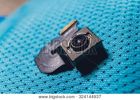 Close-up Of Camera Sensor Chip On Cloth Background.