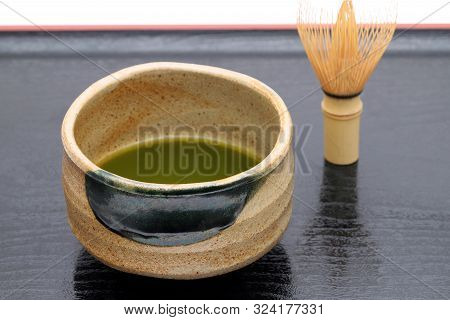 Japanese Matcha Green Tea In A Ceramic Bowl With Tea Whisk
