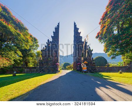 The Famous Bali Handara. The Hindu Temple With Ancient Gate With Pathway In Park Garden At Noon. Hin