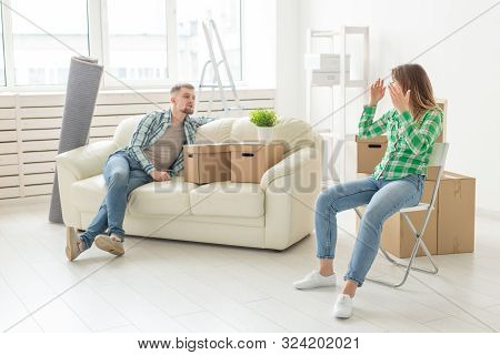 Relocation, Real Estate And Moving Concept - Young Cheerful Couple Moving Into Their New Home