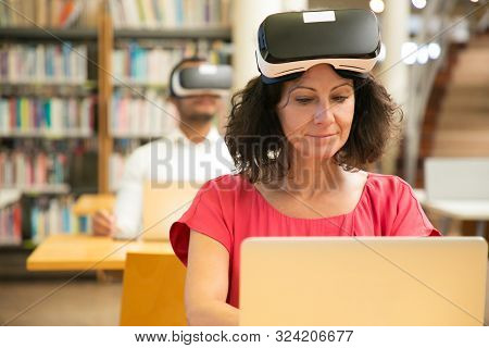 Group Of Adult Students Using Vr Headsets In Computer Class. Man And Woman In Virtual Reality Glasse
