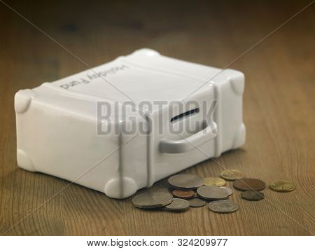 lugagge shape saving jar on the wooden table