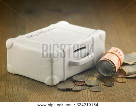 lugagge shape saving jar on the wooden table