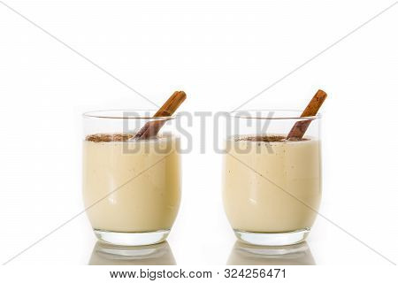 Homemade Eggnog With Cinnamon In Glass Isolated On White Background. Typical Christmas Dessert