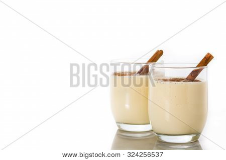 Homemade Eggnog With Cinnamon In Glass Isolated On White Background. Typical Christmas Dessert.copy 