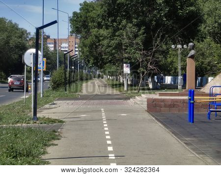 Kazakhstan, Ust-kamenogorsk, June 8, 2019: Bicycle Path In The City. Street. Urban. Green Trees