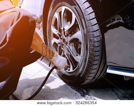 The Mechanic Is Filling The Car Tires At The Garage. The Technician Is Checking The Tire Condition T