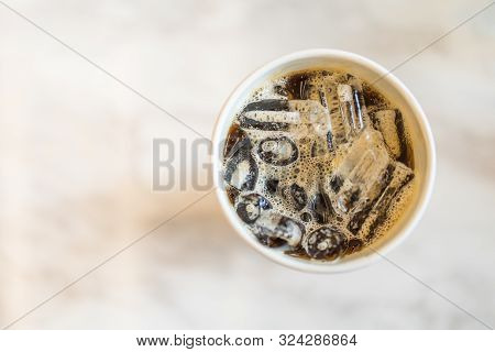 Top View Of Take Away Papercup Of Iced Black Coffee (americano) On Table With Copy Space.