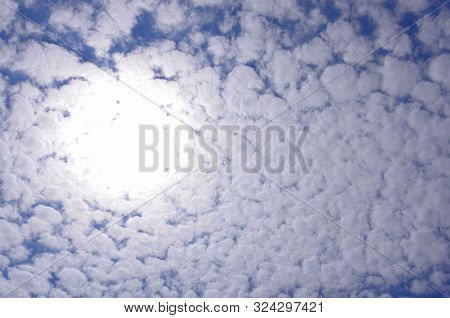 The Light Of The Sun Behind The Light White Lace Clouds.