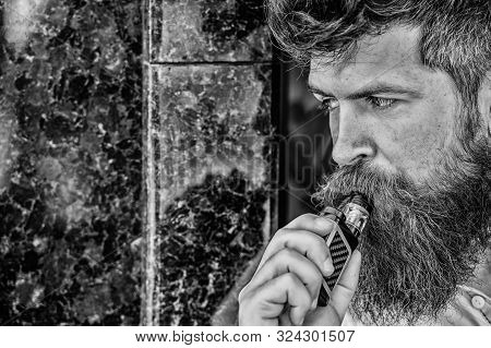 Bearded Man Smoking Vape. Man With Beard Breathe Out Smoke. Smoking Electronic Cigarette. Stress Rel