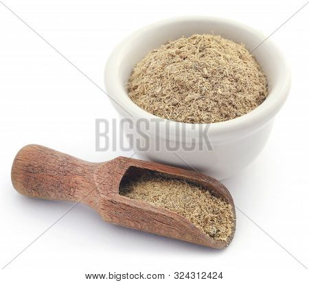 Liquorice Stick And Ground In A Small Bowl Over White Background