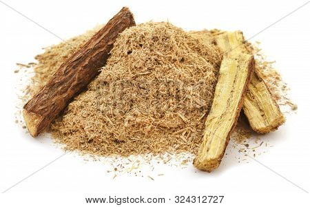 Liquorice Stick And Ground Powder Over White Background
