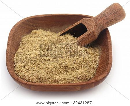 Liquorice Stick And Ground Powder In A Bowl Over White