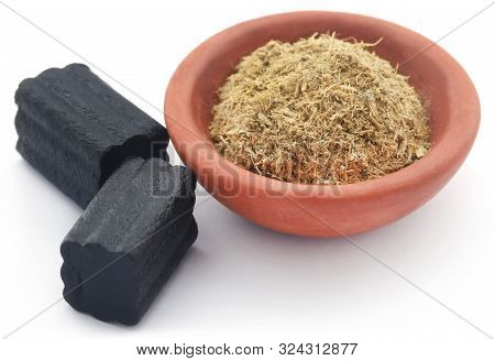 Liquorice Powder In A Bowl And Candy Over White Background
