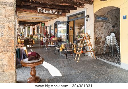 Tourists Enjoying Outdoor Bar In The Picturesque Village Morcote On The Shore Of Lake Lugano In Tici