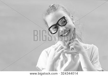 Perfect Props For Partying. Happy Little Child Looking Through Glasses Props. Funny Small Girl Weari