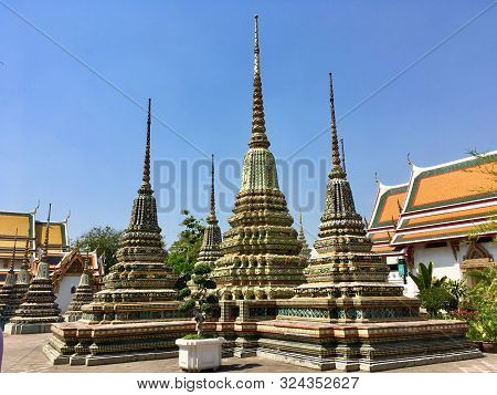 Ancient Pagoda And Stupas Decorate Around External In Wat Pho Temple In Bangkok, Thailand