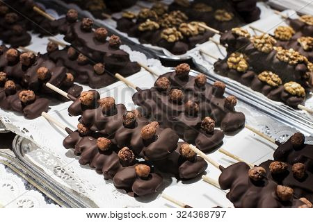 Fruits Bananas, Strawberries, Nuts, Apples, Peaches Drenched In White And Dark Chocolate.