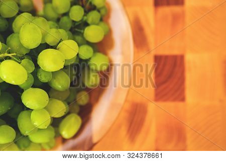 Fresh Green Grape On The Plate On The Wooden Cutting Board, Top View