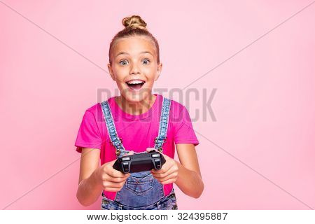 Photo Of Rejoicing Cute Nice Schoolgirl Excited About Level Complete Playing Video Games Wearing T-s