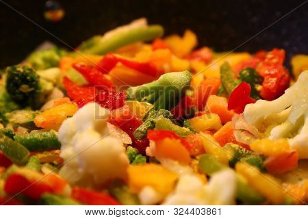 Frozen Vegetables, Including Pepper Broccoli And Cauliflower Being Cooked