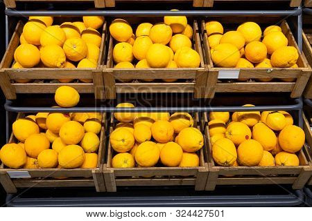 Wooden Lug Boxes With Ripe Lemons On Counter In Grocery Store