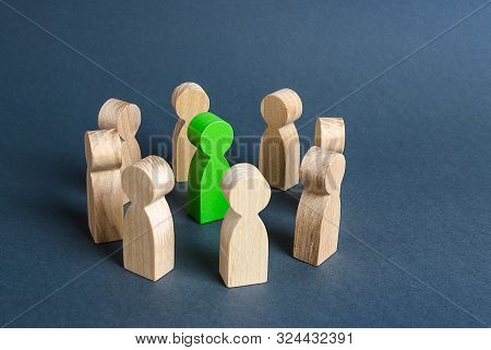 A Green Human Figure Is Surrounded By A Circle Of People. Cooperation And Collaboration. Fundraising