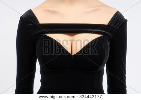 Young Female Breast In The Sexy Black Velvet Dress. Beautiful Shapes And Collarbones With Dress Neck