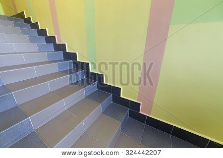 Wide Staicase Covered With Ceramic Tiles Indoors In A House Interior.