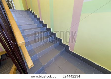 Wide Staicase Covered With Ceramic Tiles Indoors In A House Interior.