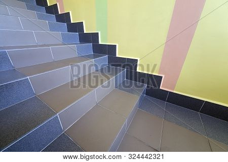 Wide Staicase Covered With Ceramic Tiles Indoors In A House Interior.