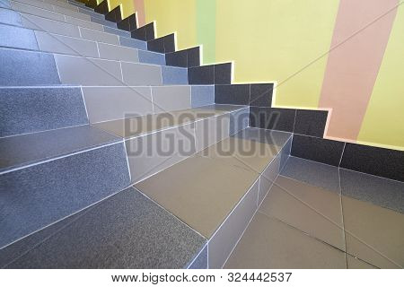 Wide Staicase Covered With Ceramic Tiles Indoors In A House Interior.