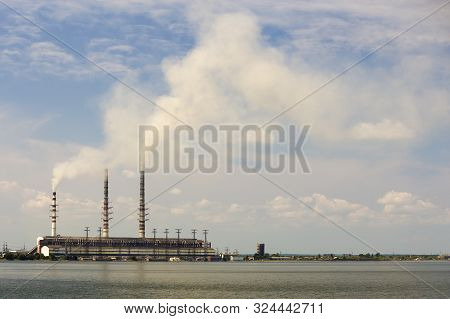 Thermal Power Station Tall Pipes With Thick Smoke Reflected In Lke Water Surface. Pollution Of Envir