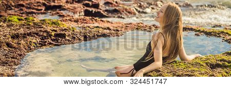 Young Woman Tourist On Pantai Tegal Wangi Beach Sitting In A Bath Of Sea Water, Bali Island, Indones